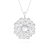 The Purity Pendant - Sterling Silver with Crystal (Size S) by Kaora Sandara Jewelry features a circular openwork design, showcasing a large central white crystal surrounded by sparkling rhinestones.