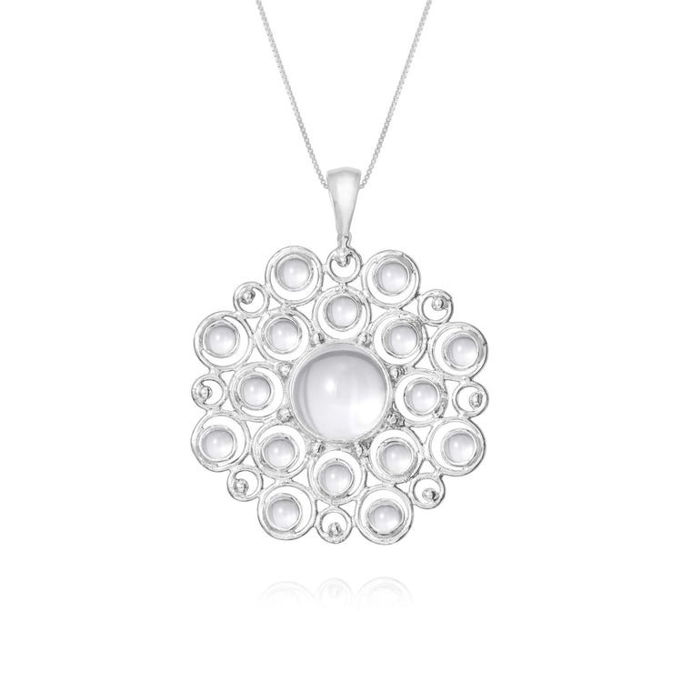 The Purity Pendant - Sterling Silver with Crystal (Size S) by Kaora Sandara Jewelry features a circular openwork design, showcasing a large central white crystal surrounded by sparkling rhinestones.
