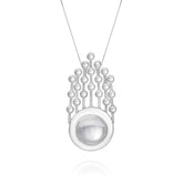 The Silver Pendant Frequency Enhancer with Crystal by Kaora Sandara Jewelry features a circular, domed silver pendant accented with small spheres inspired by rock crystal, connected by vertical lines for a sleek geometric look.