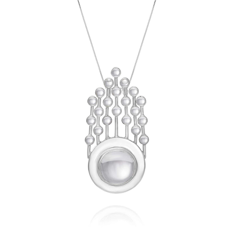 The Silver Pendant Frequency Enhancer with Crystal by Kaora Sandara Jewelry features a circular, domed silver pendant accented with small spheres inspired by rock crystal, connected by vertical lines for a sleek geometric look.