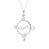 The Soul Potential Pendant by Kaora Sandara Jewelry is a sterling silver necklace featuring a large circular frame with chalcedony and crystal beads, connected by decorative wire details.