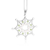 The Freedom from the Ego Pendant by Kaora Sandara Jewelry features sterling silver shaped like a web, accented with rose quartz, peridot crystals, and hangs delicately from a chain against a white background.