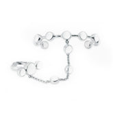 The Silver Hand Chain Crystal Path by Kaora Sandara Jewelry features two rings linked by a delicate chain, each adorned with crystal sphere gemstones for a modern, minimalist look with gemstone elegance.