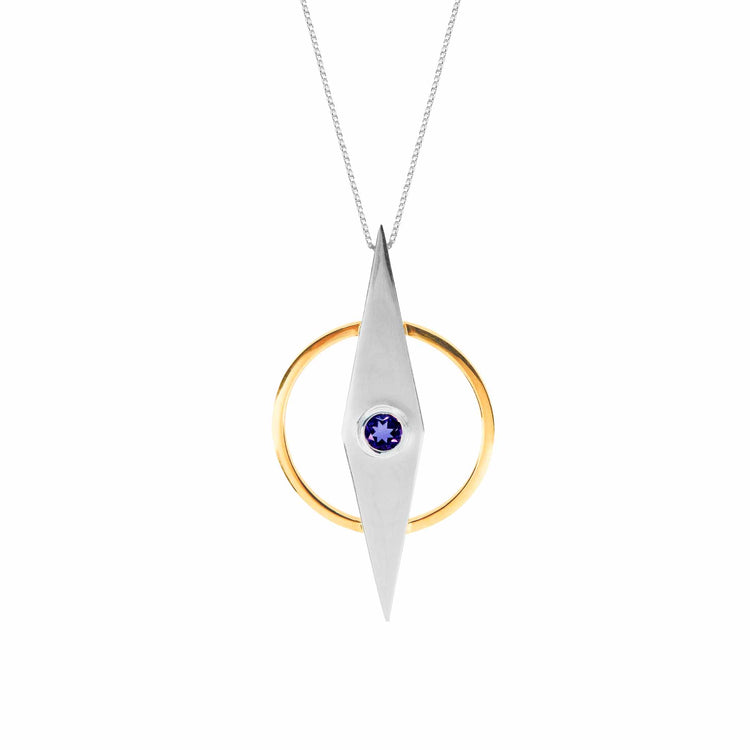 The Intuition Pendant by Kaora Sandara Jewelry features a sterling silver and gold-plated elongated diamond design with a central blue amethyst, elegantly suspended from a fine silver chain.