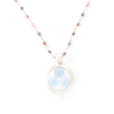 The Silver Pendant Crystal Peace necklace by Kaora Sandara Jewelry features a sterling silver chain with small pink and purple beads, a circular pendant, and three light blue chalcedony sphere gemstones. Shown on a plain white background.