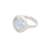 The Silver Ring Crystal Peace with Chalcedony - Size S from Kaora Sandara Jewelry features three round pale blue chalcedony stones in a circular setting and has an open, adjustable sterling silver band.