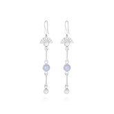 The Peace of Mind Earhooks by Kaora Sandara Jewelry feature sterling silver with a fan-shaped top, light blue chalcedony gemstone center, and blue and white crystals linked below for elegant serenity.