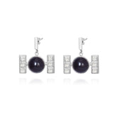 Kaora Sandara Jewelry’s Silver Earhooks Health Formula features sterling silver drop earrings with a central round Black Agate and three square crystals on each side, creating a geometric, modern look with secure earhooks.