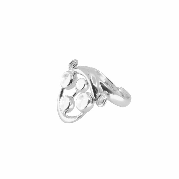 The Magic Path Ring by Kaora Sandara Jewelry features sterling silver with crystal gemstones, showcasing an abstract design with four round, raised elements and smooth, curved lines.