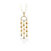 Kaora Sandara Jewelry's Abundance Flow Pendant features sterling silver and gold plating with crystal and citrine accents in a semicircle design, symbolizing abundance, hanging from a delicate chain.