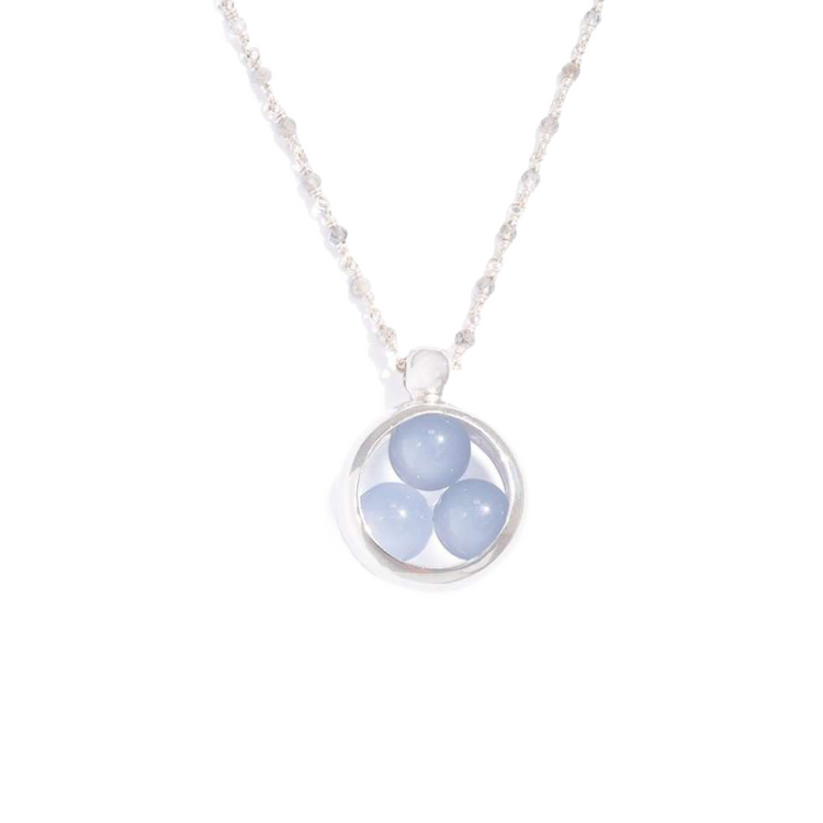 The Silver Pendant Crystal Peace by Kaora Sandara Jewelry features a sterling silver round pendant with three light blue chalcedony sphere gemstones arranged in a triangle on a silver-chalcedony chain, inspired by the chakra system. Size L.