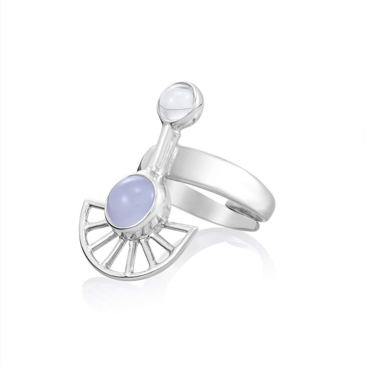 The Peace of Mind Ring by Kaora Sandara Jewelry features sterling silver, crystal, and chalcedony in a modern fan-shaped design with two round pale lavender stones. Embrace tranquility with this elegant piece. Displayed on a white background.