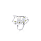 The Body Relaxation Ring by Kaora Sandara Jewelry features sterling silver with a crystal center, accented by chalcedony and peridot stones in an openwork leaf design that evokes energy flow.