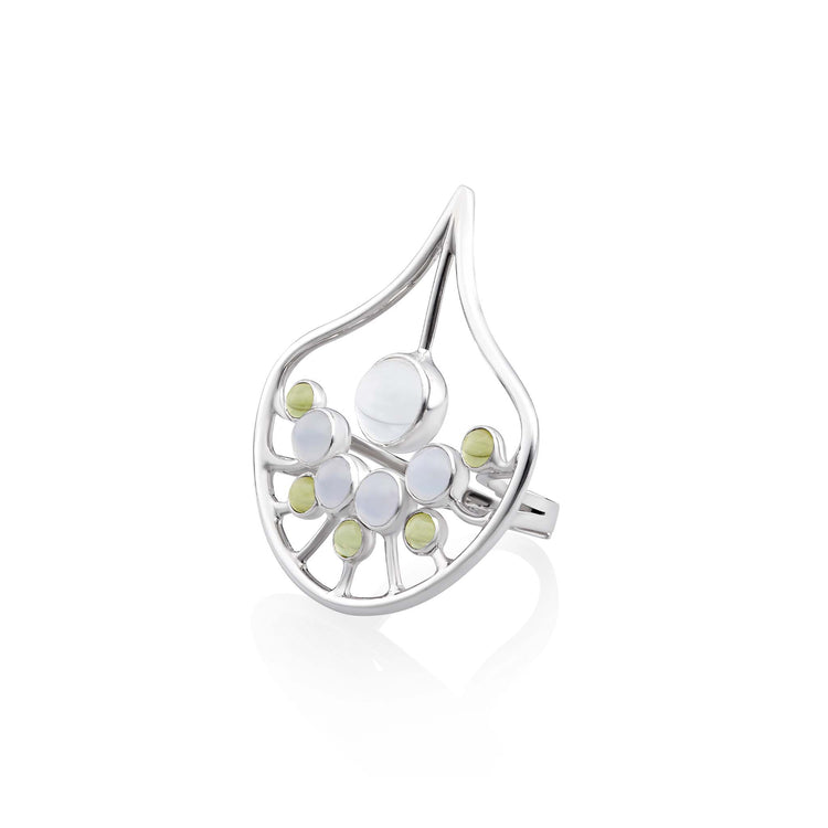 The Body Relaxation Ring by Kaora Sandara Jewelry is a sterling silver piece featuring crystal, chalcedony, and peridot in an open artistic leaf design to promote positive energy flow.