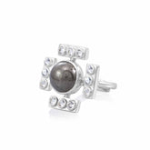 The Confidence Ring by Kaora Sandara Jewelry features sterling silver with a central round pyrite stone, accented by four rectangular sections each set with three crystals, creating a bold, cross-inspired design.