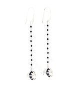 Kaora Sandara Jewelry’s Magic Time Night Earhooks are long sterling silver 925 earrings with a beaded black agate and spinel chain, finished with round silver pendants featuring cut-out star designs.