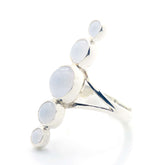 The "Silver Ring Harmony with Chalcedony Sphere Gemstones" by Kaora Sandara Jewelry is crafted from sterling silver 925 and features five round, white Chalcedony stones of varying sizes set in a diagonal cluster on a polished band. Photographed on white.