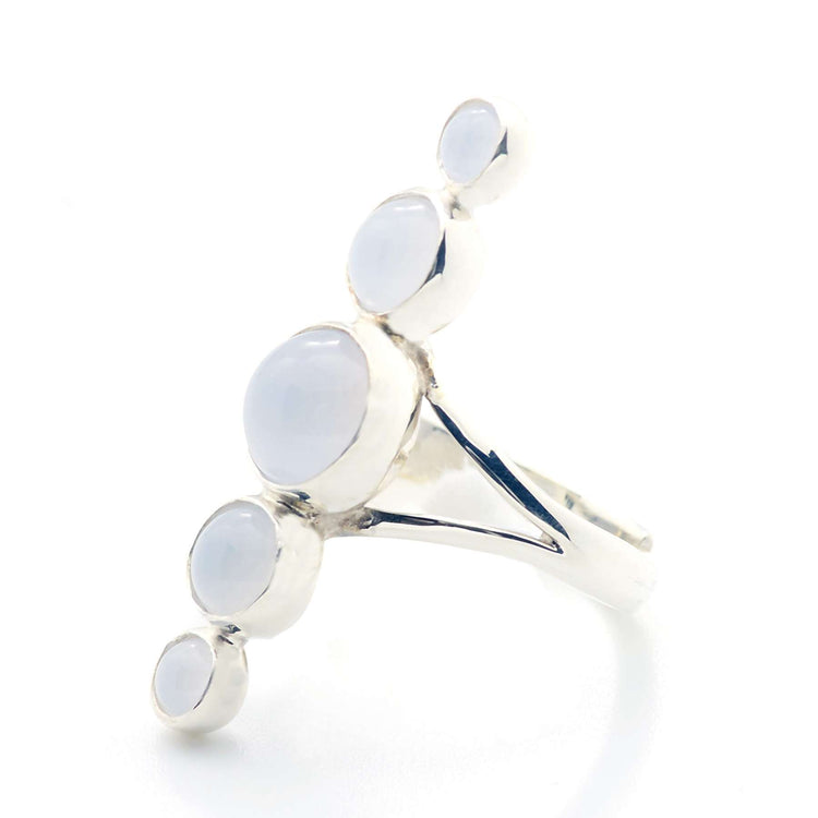 The "Silver Ring Harmony with Chalcedony Sphere Gemstones" by Kaora Sandara Jewelry is crafted from sterling silver 925 and features five round, white Chalcedony stones of varying sizes set in a diagonal cluster on a polished band. Photographed on white.