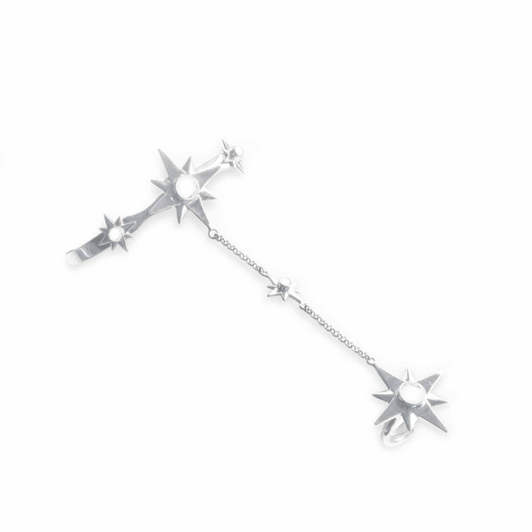 The Silver Hand Chain Magic Star with Crystal Sphere Gemstones by Kaora Sandara Jewelry features a silver ear cuff and ring linked by a chain, each adorned with eight-pointed star designs and Rock crystal gemstones, symbolizing intuition.