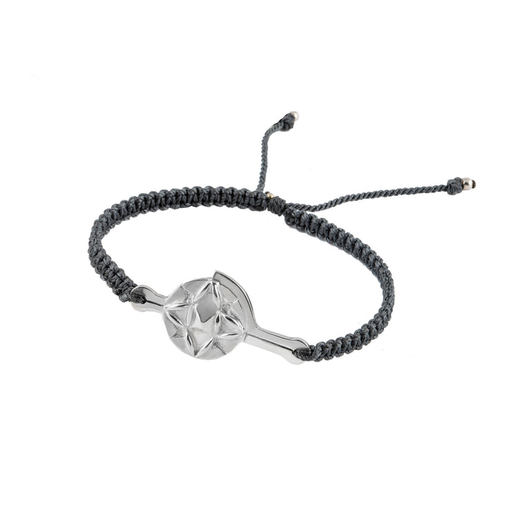 The Silver Male Bracelet On Dark Grey String With Code Transition by Kaora Sandara Jewelry features a braided cord, an adjustable knot, and a sterling silver star-shaped geometric charm at the center.