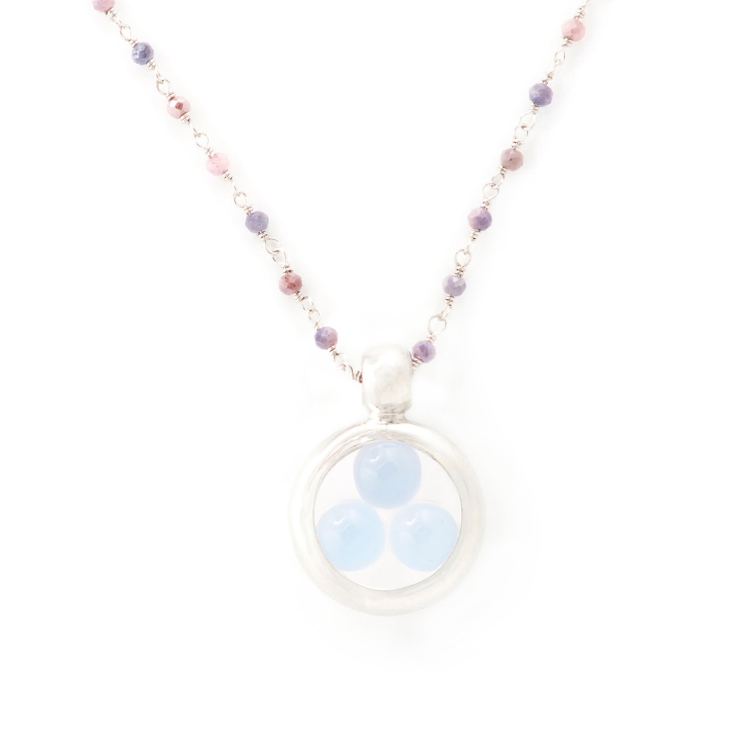 The Silver Pendant Crystal Peace necklace by Kaora Sandara Jewelry features a sterling silver chain with small pink and purple beads, a circular pendant, and three light blue chalcedony sphere gemstones. Shown on a plain white background.