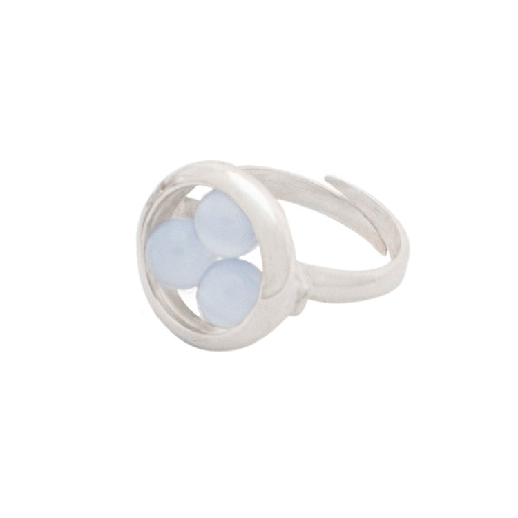 The Silver Ring Crystal Peace with Chalcedony - Size S from Kaora Sandara Jewelry features three round pale blue chalcedony stones in a circular setting and has an open, adjustable sterling silver band.