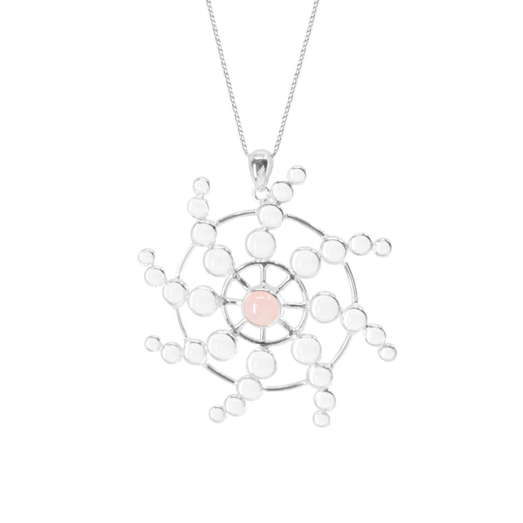 The Perfection of Life Pendant by Kaora Sandara Jewelry features sterling silver shaped in a geometric starburst, with a central Rose Quartz and crystals—a radiant symbol of life's perfection.