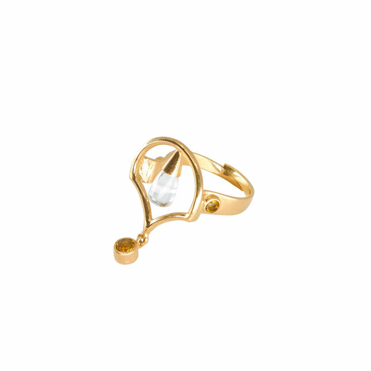The Kaora Sandara Jewelry Abundance Flow Ring features an open, asymmetrical gold-plated sterling silver design with a central crystal and a dangling round citrine, shown on a white background.