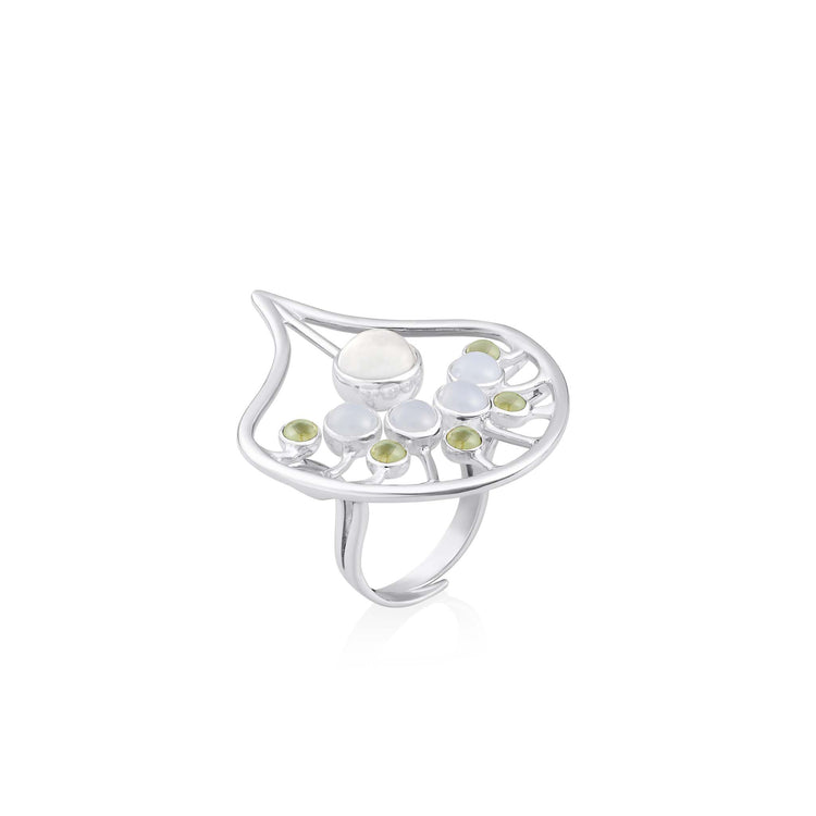 The Body Relaxation Ring by Kaora Sandara Jewelry features sterling silver with a crystal center, accented by chalcedony and peridot stones in an openwork leaf design that evokes energy flow.
