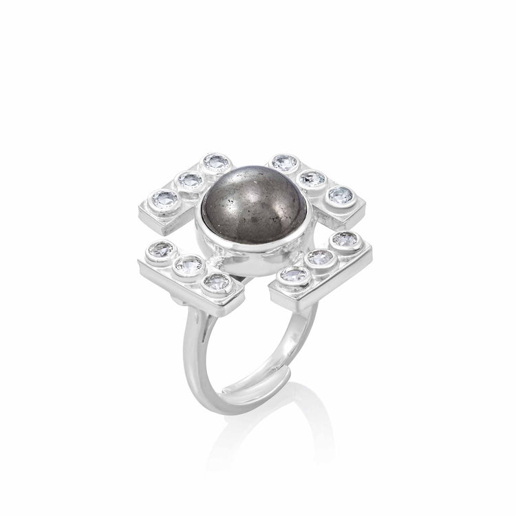 The Confidence Ring by Kaora Sandara Jewelry features a large round pyrite center in sterling silver, accented with geometric crystal rhinestones on a polished band, shown against a white background.