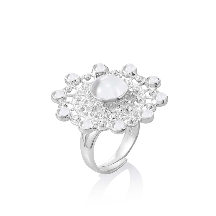 The Kaora Sandara Jewelry Purity Ring, size S, is crafted in sterling silver with a central round white crystal and smaller crystals in a lace-like design. It’s shown against a white background.