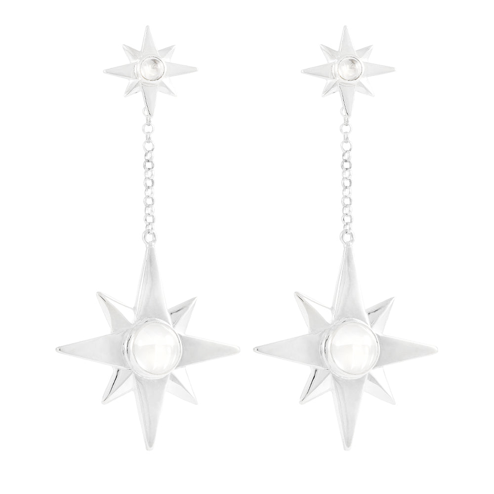Kaora Sandara Jewelry’s Silver Earstuds on Chain Magic Star feature dangling eight-pointed stars with crystal sphere gemstones, linked by a short chain to smaller matching stars at the top.