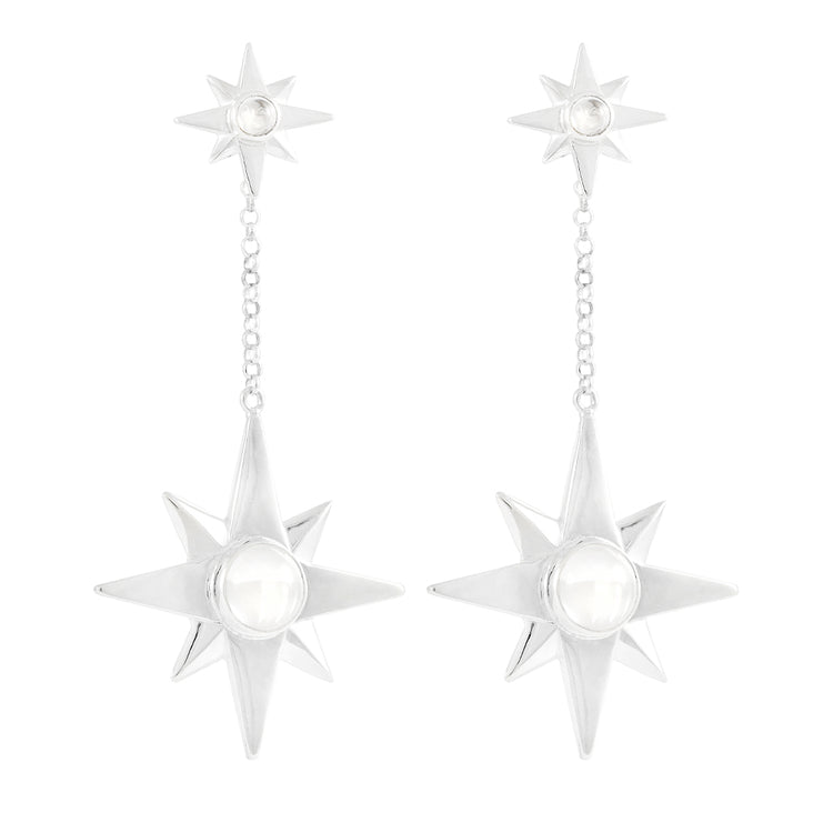 Kaora Sandara Jewelry’s Silver Earstuds on Chain Magic Star feature dangling eight-pointed stars with crystal sphere gemstones, linked by a short chain to smaller matching stars at the top.